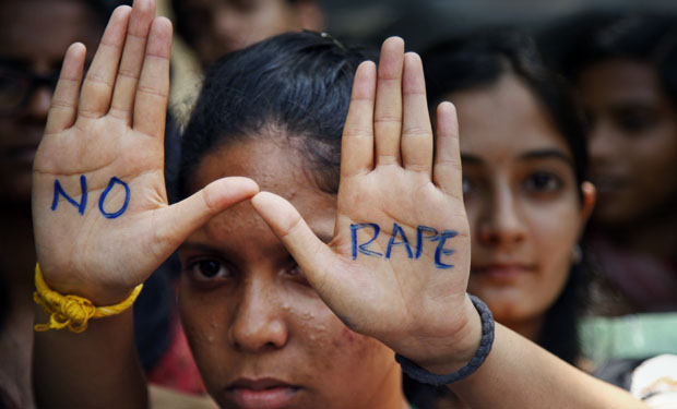 An Indian student displays "NO RAPE" message painted on her hands during a demonstration to demand death sentence for four men convicted of rape and murder of a student on a moving bus in New Delhi bus last year, in Hyderabad, India, Friday, Sept. 13, 2013. A judge on Friday ordered all four to the gallows for a brutal attack that left the young woman with such severe internal injuries that she died two weeks later. (AP Photo/Mahesh Kumar A.) India Gang Rape