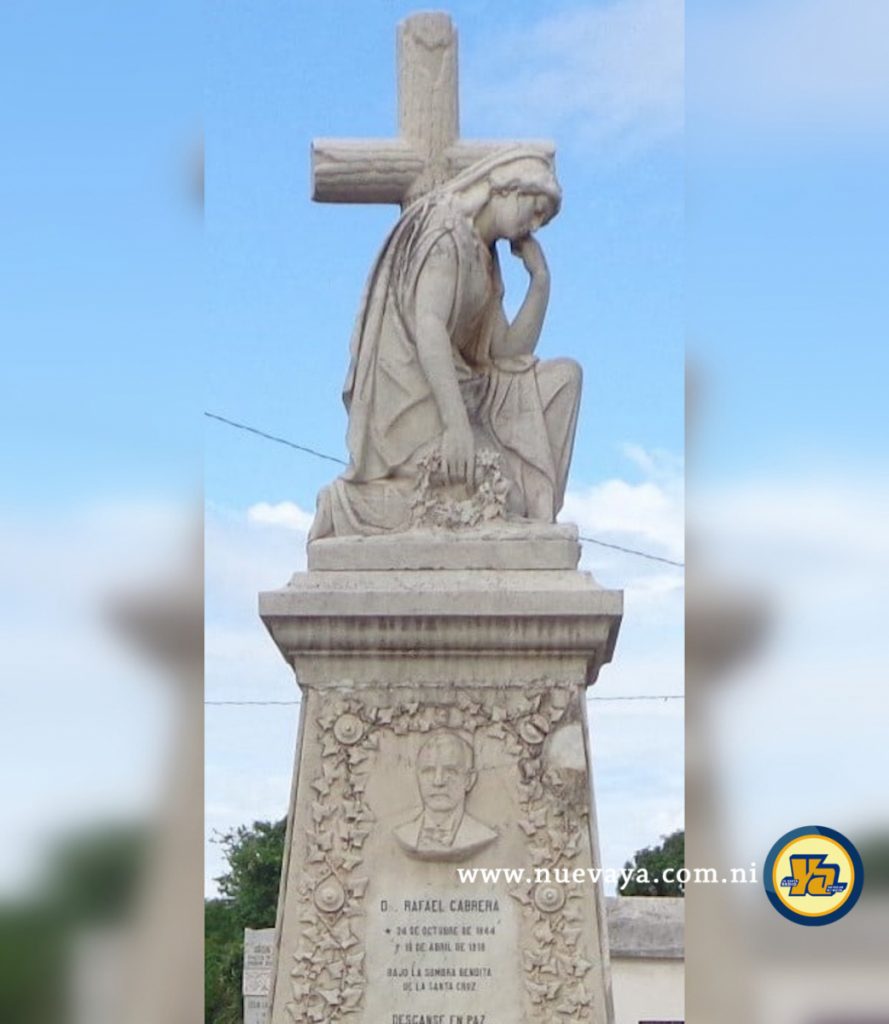 Escultura de una dama entristecida delante de una cruz de madera